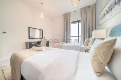 a white bedroom with two beds and a window at High Floor 2BR With a View of the Dubai Marina Canal Steps Away From the Beach , Shams 1, JBR by Deluxe Holiday Homes in Dubai