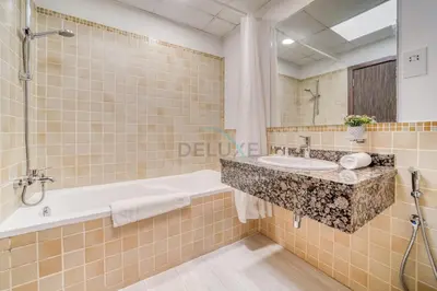 a bathroom with a sink and a bath tub at High Floor 2BR With a View of the Dubai Marina Canal Steps Away From the Beach , Shams 1, JBR by Deluxe Holiday Homes in Dubai