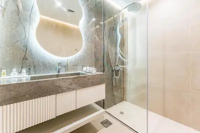 a bathroom with a sink and a shower at Refurbished 1BR High-Floor Unit with Partial City & Sea Views, Walking Distance to the Beach, Elite Residence, Dubai Marina by Deluxe Holiday Homes in Dubai