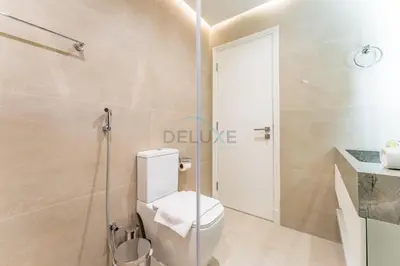 a bathroom with a toilet and a glass shower at Refurbished 1BR High-Floor Unit with Partial City & Sea Views, Walking Distance to the Beach, Elite Residence, Dubai Marina by Deluxe Holiday Homes in Dubai