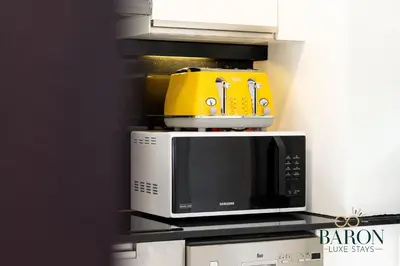 a yellow and white microwave sitting on top of a counter at The Exquisite in Dubai