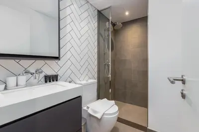 a bathroom with a white sink and a toilet at Upgraded Brand New Studio in Belgravia 2, JVC - Allsopp & Allsopp in Dubai