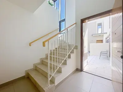 a staircase in a house with a window at Modern Five Bedroom Villa with BBQ and Garden in Dubai