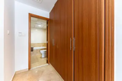 a wooden closet in a bathroom with a toilet at HAVN - 2-Storey Apartment with Dubai Marina Views in Dubai