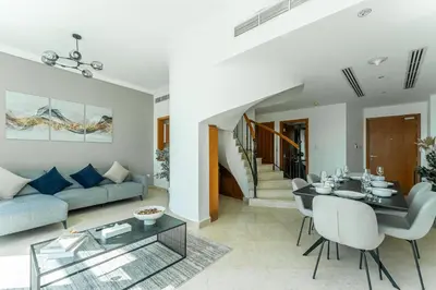 a living room with a couch and a table at HAVN - 2-Storey Apartment with Dubai Marina Views in Dubai