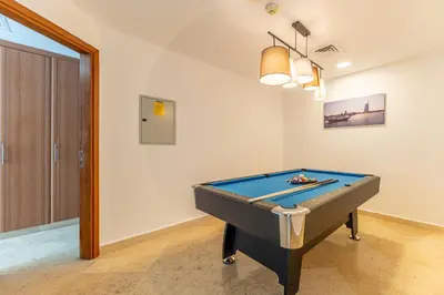 a room with a pool table in it at HAVN - 2-Storey Apartment with Dubai Marina Views in Dubai