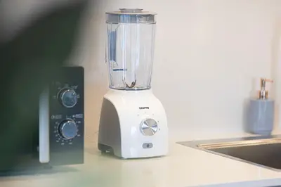 a blender sitting on a counter next to a sink at Stay in the #1 Burj & Fountain View 4BR Apartment in Dubai