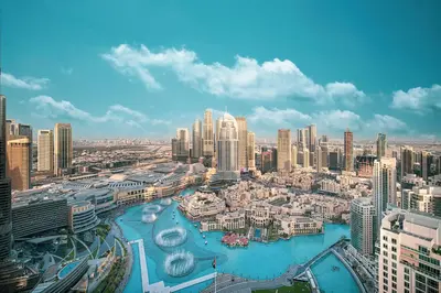 a view of a city with a river and buildings at Stay in the #1 Burj & Fountain View 4BR Apartment in Dubai