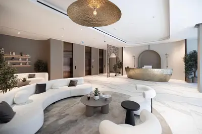 a lobby with white couches and a table at Modern & Luxurious Studio - Near CircleMall in Dubai