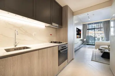 a kitchen with a sink and a counter top at Modern & Luxurious Studio - Near CircleMall in Dubai