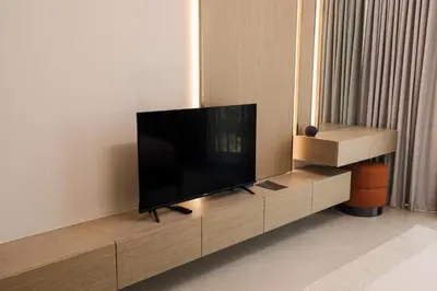 a flat screen tv sitting on a entertainment center in a room at Elegant 1BR in JVC in Dubai