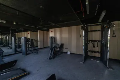 an empty gym with several treadmills and machines at Elegant 1BR in JVC in Dubai
