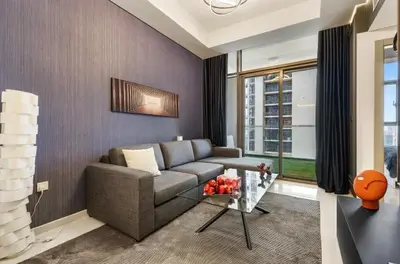 a living room with a couch and a table at Luxury 2BR above the clouds on38 in Dubai