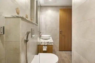 a bathroom with a toilet and a sink at Luxury 2BR above the clouds on38 in Dubai