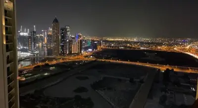 a view of a city skyline at night at Luxury 2BR above the clouds on38 in Dubai