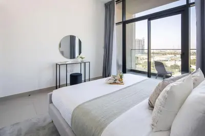 a bedroom with a large bed and a large window at Frank Porter - Prive Residence in Dubai
