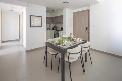 a dining room with a table and chairs in a kitchen at Frank Porter - Prive Residence in Dubai