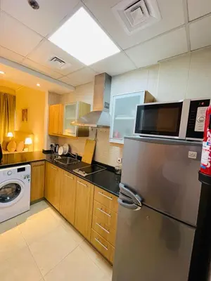 a kitchen with a stainless steel refrigerator and a microwave at Big Studio Apartment in Dubai Marina Walking to JBR Beach, Cruise and DMCC Metro in Dubai