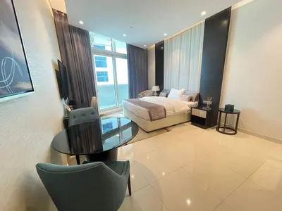 a bedroom with a bed and a glass table at Unmatched luxury perfectly located next to Dubai Mall and Burj Khalifa in Dubai
