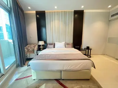 a bedroom with a large bed and a chair at Unmatched luxury perfectly located next to Dubai Mall and Burj Khalifa in Dubai
