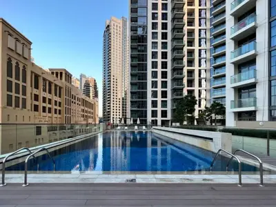 a large swimming pool in a city with tall buildings at Lux 1BR Apt with BurjKhalifa Views in DowntownDubai in Dubai