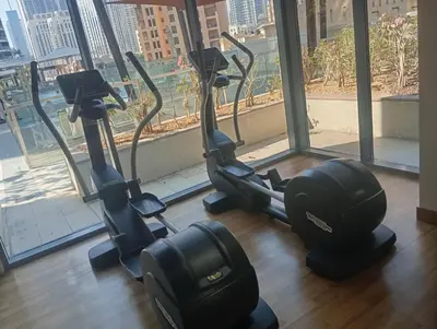 a gym with two exercise bikes in front of a window at Lux 1BR Apt with BurjKhalifa Views in DowntownDubai in Dubai