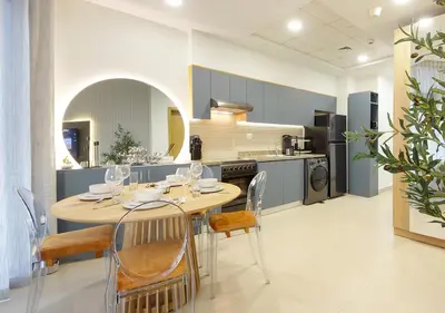 a kitchen with a table and chairs in a kitchen at Lux 1BR Apt with BurjKhalifa Views in DowntownDubai in Dubai