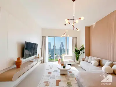 a living room with a couch and a tv at Grande Luxury 1B With Balcony & City Views in Dubai
