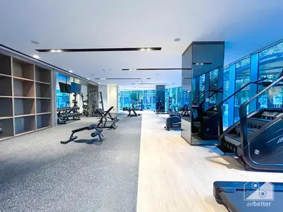 a gym with treadmills and ellipticals in a building at Grande Luxury 1B With Balcony & City Views in Dubai