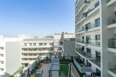an aerial view of an apartment building with a courtyard at Smartly Designed Studio in JVC in Dubai