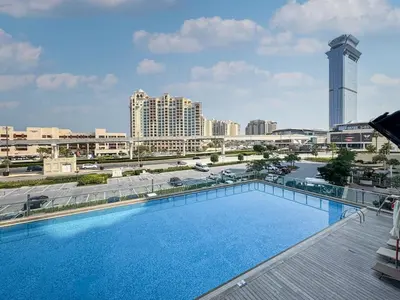 a large swimming pool on the roof of a building at Chic Waterfront Studio in Palm Views West in Dubai