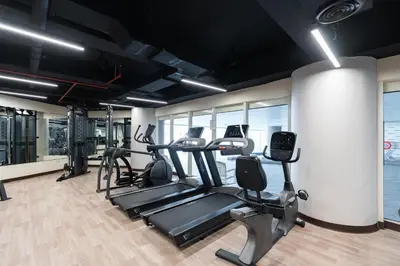 a gym with treadmills and elliptical machines at Stylish 1-Bedroom with Breathtaking Views at Dubai Marina in Dubai