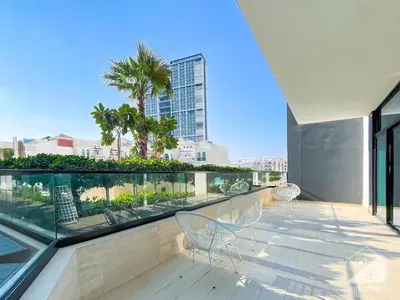 a balcony with chairs and a view of a city at Elegant 2 Bedroom Apartment -Binghatti Emerald JVC in Dubai