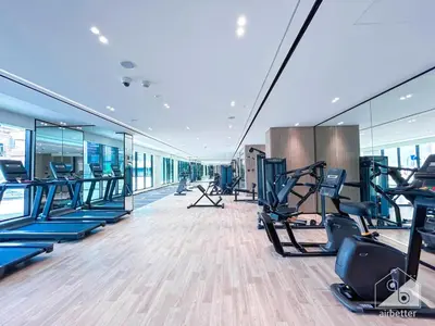 a gym with treadmills and cardio equipment in a building at Elegant 2 Bedroom Apartment -Binghatti Emerald JVC in Dubai
