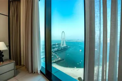 a hotel room with a view of the ocean at Werova - Sea View 3BR with Hotel Facilities Access in Dubai