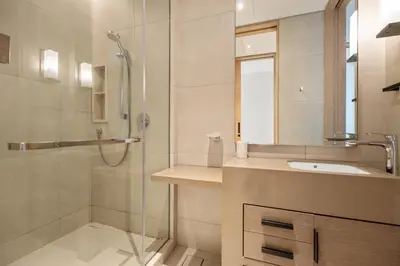 a bathroom with a shower and a sink at Werova - Sea View 3BR with Hotel Facilities Access in Dubai