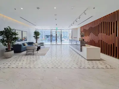 a lobby with couches and tables in a building at Azure - 1-Bed Luxury by Crystal Lagoon, Downtown in Dubai