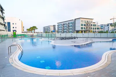 a large swimming pool in a city with buildings at Great deal Magnificent Brand New with Private PooL in Dubai