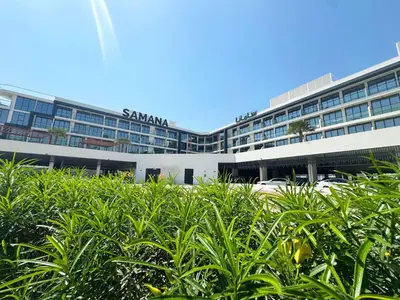 a large building with a parking lot in front of it at Great deal Magnificent Brand New with Private PooL in Dubai