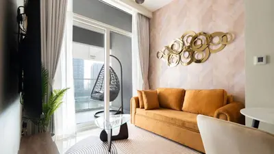a living room with a couch and a window at Keyrock Living - Luxury 1BR with Lake View at Reva in Dubai