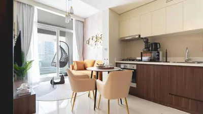 a kitchen and dining room with a table and chairs at Keyrock Living - Luxury 1BR with Lake View at Reva in Dubai