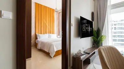 a bedroom with a bed and a desk and a window at Keyrock Living - Luxury 1BR with Lake View at Reva in Dubai