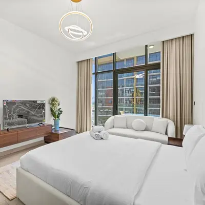 a bedroom with two white beds and a large window at Azizi Riviera 35 - Studio with full Kitchenet - Ideal for monthly in Dubai