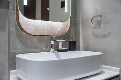 a bathroom with a white sink and a mirror at StayShort - Sleek Studio in Jumeirah Village Triangle in Dubai