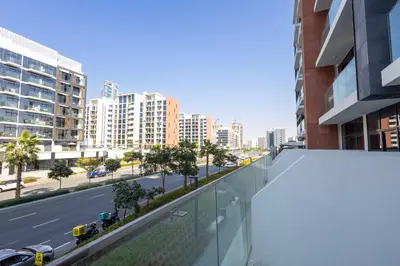 a view of a city street from the balcony of a building at 10 Mins from Downtown Pool Gym Large Terrace in Dubai