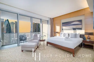 a bedroom with a bed and a desk and a chair at LUX The EMAAR Fashion Avenue Studio 2 in Dubai