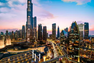 a city skyline with skyscrapers and traffic at dusk at LUX The EMAAR Fashion Avenue Studio 2 in Dubai