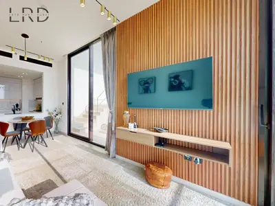 a living room with an orange striped wall at Modern Smart Home 2BR with Private Pool in JVC in Dubai