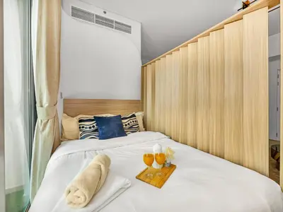 a bedroom with two beds with a tray of drinks at Luxurious 2BR Stay Marina View in Dubai