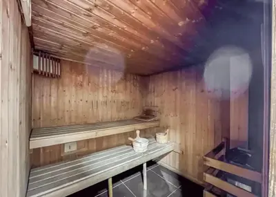 a sauna with wooden walls and benches in a room at Luxurious 2BR Stay Marina View in Dubai